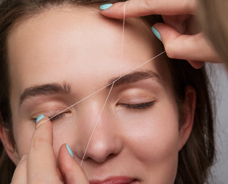 Woman getting eyebrow threading at Hollywood Eyebrow Salon